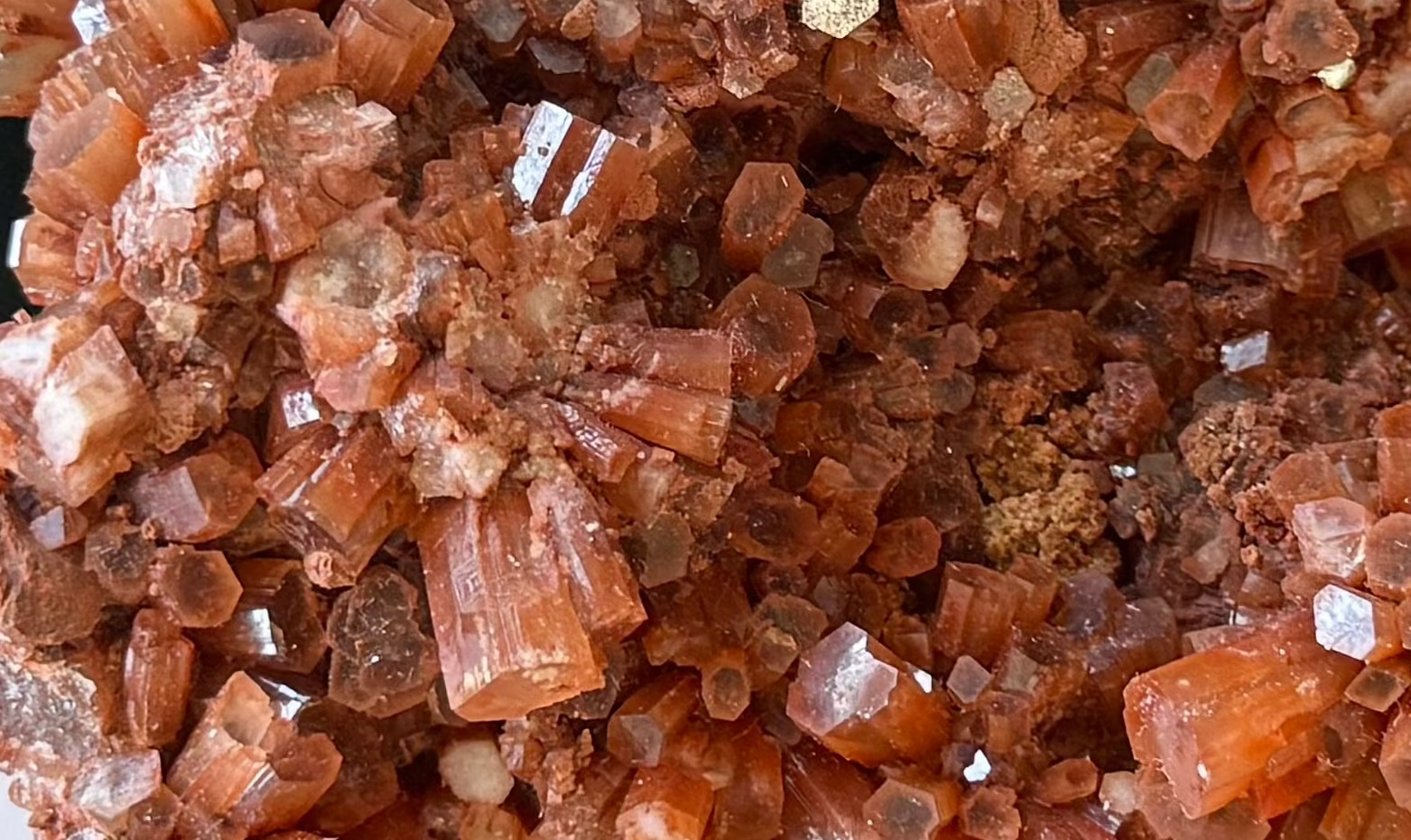 Aragonite, cluster-y redish to pale milky white stone.